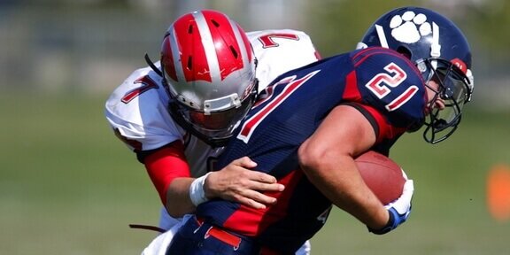 American footballers break down the barrierss